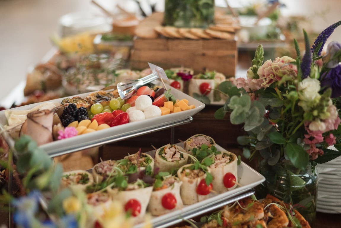 A grazing table of fruit, canapés and fresh flowers